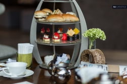 Traditional three tiered tea tray with an array of local & British delicacies